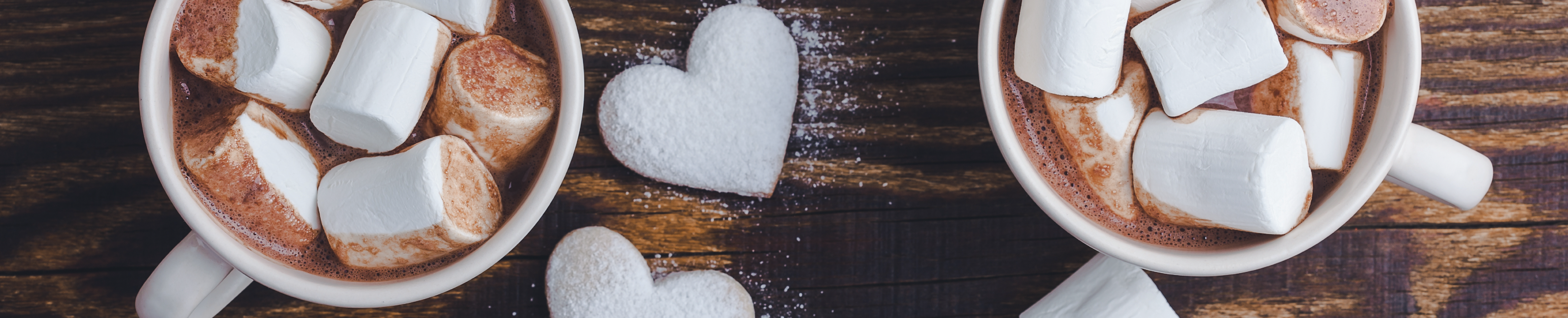 two mugs of hot cocoa with marshmallows