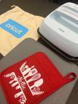 Cricut Heat Press 3 with example of an iron-on decal on a pot holder. 