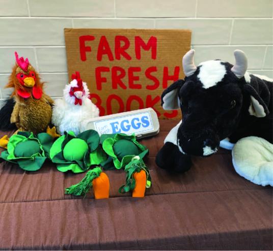 cow and chicken stuffed animals, play vegetables and a sign that says farm fresh books