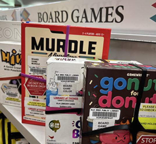 Image of board games sitting on a shelf in the library
